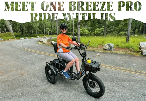 A person in an orange shirt and helmet sits on a paved road lined with trees atop the Meet One Breeze Pro Fat Tire Electric Trike, with "Meet the Breeze Pro Ride With Us" above.