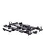 The NV™ 2.0 is a folded black metal bike rack with wheel holders and support arms for vehicle mounting, displayed on a white background.