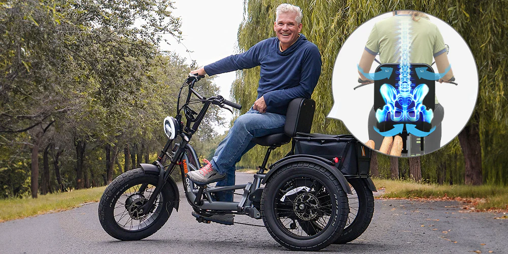 A man sits on an electric tricycle on a paved path; an inset graphic shows a spinal illustration highlighting support features.