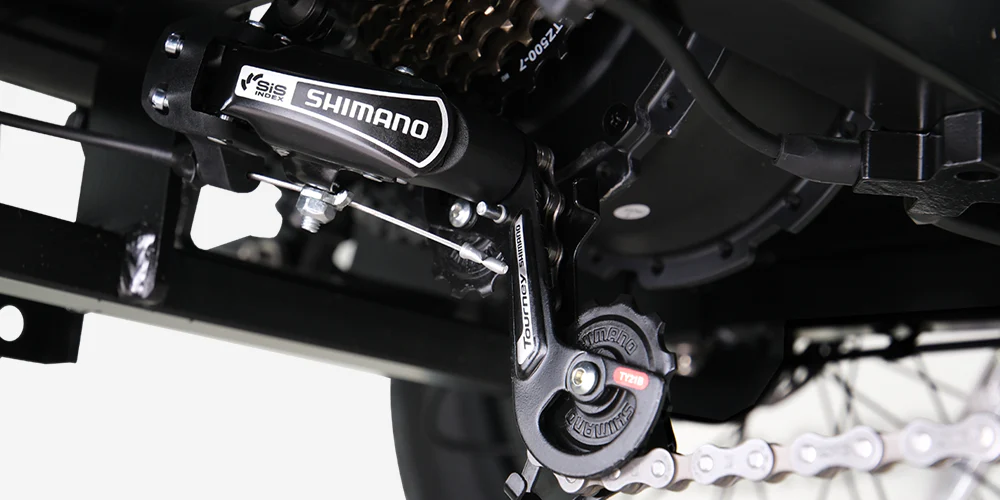Close-up view of a Shimano bicycle derailleur system, showing the gear mechanism, chain, and sprockets in detail.