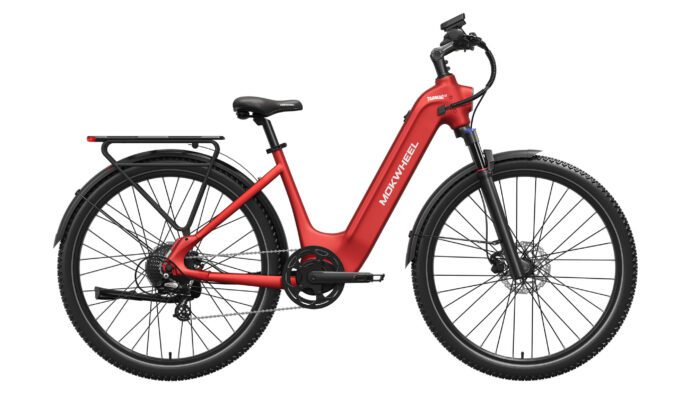 Red electric bicycle with a step-through frame, rear rack, front suspension fork, disc brakes, and fenders on both wheels, shown in a side profile view.