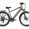 A gray electric bicycle with front suspension, rear cargo rack, fenders, disc brakes, and a mid-step frame is shown in a side view.