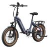 The Slate Ebike is a blue, foldable electric bike featuring wide tan tires, front suspension, a rear cargo rack, and a step-through frame, shown from the front angle.