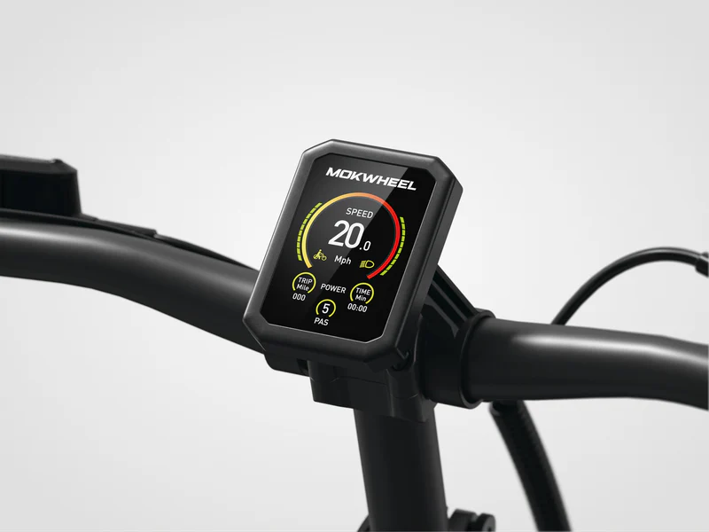 A digital display mounted on a bicycle handlebar shows speed, power, and pedal assist level information.
