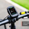 Close-up of the Slate Ebike display on the handlebars, showing speed, battery level, and pedal assist info, with a “Removable Display” label in the corner.