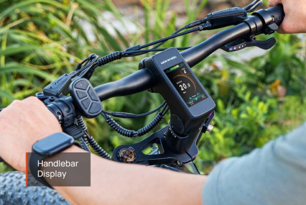Close-up of the Onyx ST Ebike handlebar with an electronic display showing speed and battery level as a rider grips the handlebars.