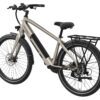 The Mesa Lite Ebike, shown from a rear-side angle, features a beige frame, black rear rack, disc brakes, and a frame-mounted battery.