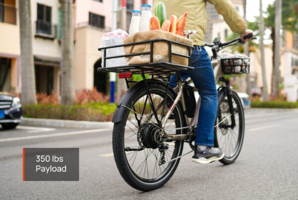 A person rides the Asphalt Ebike with a rear basket full of groceries and other items, showing a "350 lbs Payload" label.