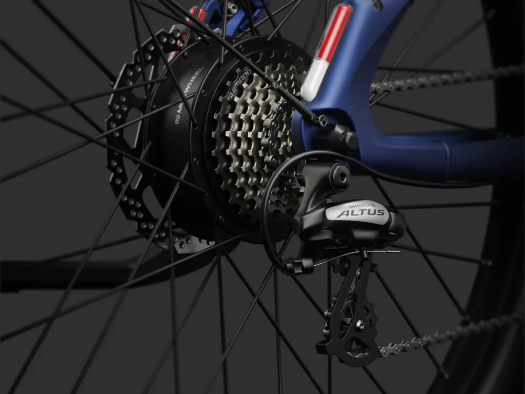 Close-up of a bicycle rear wheel showing the Shimano Altus derailleur, cassette, and spokes against a dark background.