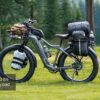 Tor Plus Ebike loaded with camping gear and bags, parked on grass by a lake and forest. Text overlay: "400 lbs Payload".