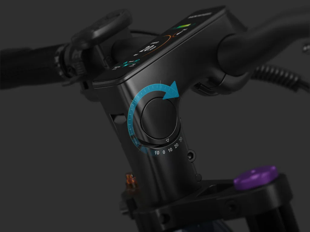 Close-up of an electric bike handlebar showing a numbered dial with a blue arrow, digital display, and part of the brake lever and wiring.