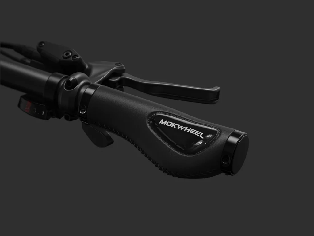 Close-up of a black bicycle handlebar grip with the brand name "Mokwheel" on a dark background.