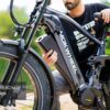 A person removes the battery from a black Onyx Ebike outdoors. Text overlay reads, "Up to 80 Mile Range.