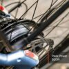 Close-up of the Tarmac Ebike’s rear wheel hub motor labeled “750W 48V,” featuring a brake disc and a text overlay reading “Peak Power 920W.”.