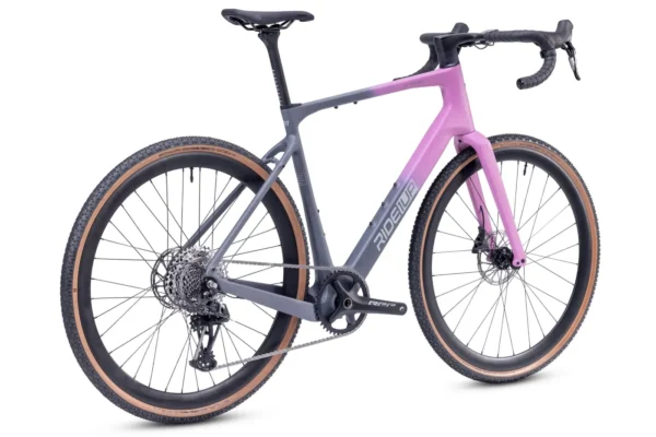 The CF Racer1 is a modern gravel bike with drop handlebars, a pink and gray frame, disc brakes, and tan-walled tires, shown from a rear side angle.