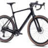 The CF Racer1 is a black gravel bike with drop handlebars, disc brakes, wide tan wall tires, and a carbon frame, displayed against a white background.