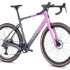 The CF Racer1 gravel bike in gray and pink features drop handlebars, disc brakes, and tan-walled tires, displayed from a side angle on a white background.