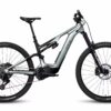 A modern full-suspension electric mountain bike with large knobby tires, a central motor, and disc brakes, viewed from the side against a white background.