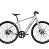 Aventon silver electric commuter bicycle with black tires and handlebars.
