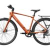 Orange Mokwheel electric commuter bike with a rear rack, fenders, and disc brakes.