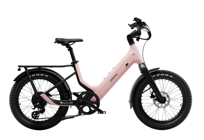 Light pink Urtopia step-through electric bike with thick tires and a rear cargo rack.