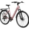 Dusty pink Mokwheel electric city bike with a rear cargo rack, fenders, and front suspension.