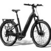 Matte black Aventon step-through electric bicycle with a rear cargo rack, fenders, and disc brakes.