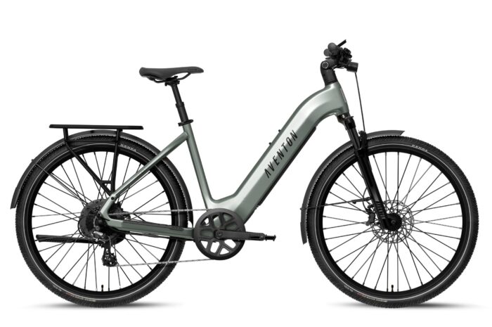 Sage green Aventon step-through electric bike with a rear rack, fenders, and disc brakes.