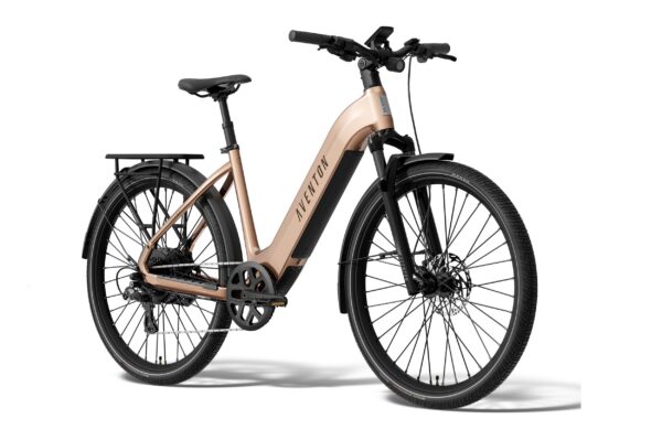 Rose gold Aventon step-through electric bicycle with a rear rack, fenders, and black components.