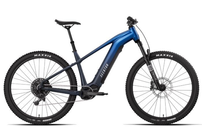 Blue Aventon electric mountain bike with knobby tires and front suspension.