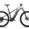 Aventon electric mountain bike with knobby tires, a suspension fork, and a two-tone silver and dark gray frame.