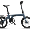 A blue Urtopia folding electric bike with a rear rack and small wheels.