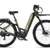 Olive green Urtopia step-through electric bike with a front rack, rear rack, and knobby tires against a white background.